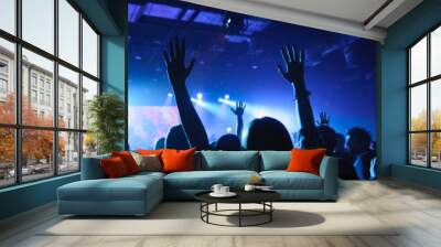 hands of fans raised up, during a concert, show or performance Wall mural