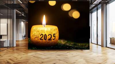 A lit candle with the number 2025 written on it Wall mural