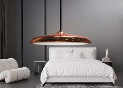 Different modern streamlined mirror copper chandeliers. Metal copper disk shaped pendant lamps. Loft style Wall mural