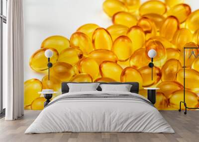 Fish Oil Capsules on a White Surface. Healthy Background and Medicine Concept. Omega 3 Natural Fat in Healthy Lifestyle and Sport Dieting. Yellow Pills with Cod Liver Oil Medicines Wall mural