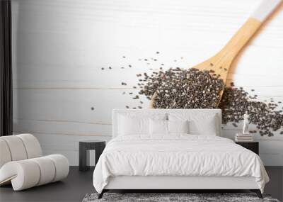 Chia seeds in wooden spoon. Superfood with copy space on white background Wall mural