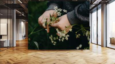 Little boy holding wildflowers in his hands in summer Wall mural