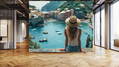 Tourist girl enjoying view of picturesque village Wall mural