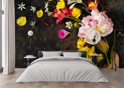 Various colored flowers in a kraft envelope on an old dark concrete background. Fantasy flower card Wall mural