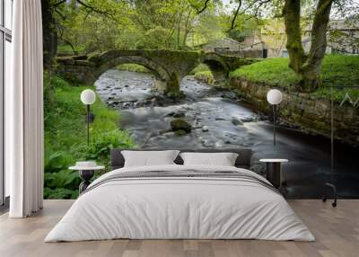 A long exposure photograph of the ancient pack horse bridge at Wycoller, Lancashire Wall mural