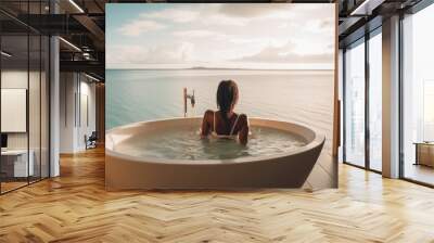 Black woman relaxing in a bathtub near ocean Wall mural