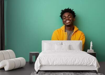 Portrait of a happy African American teenage boy isolated on a bright background Wall mural