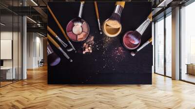 make up brushes with powder and rouge on a black wooden background Wall mural