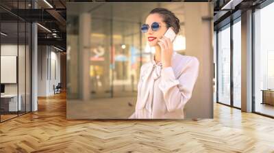 Elegant woman doing a phone call Wall mural