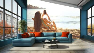 Girl chatting at the beach Wall mural