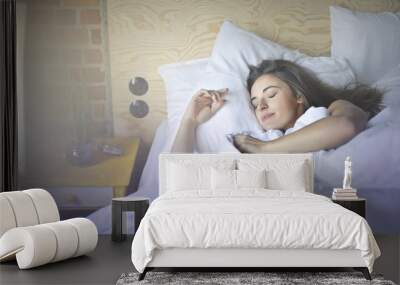 Pretty woman sleeping in hotel bed  Wall mural