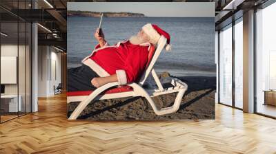 Santa Claus relaxing at the beach Wall mural