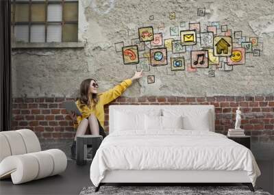 Technological woman sitting on the ground Wall mural