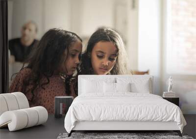 two little girls sisters look at the smartphone Wall mural