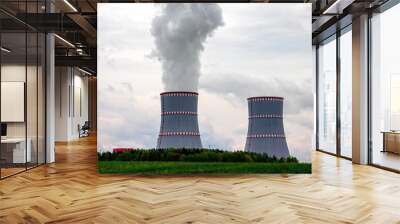 Two cooling towers close-up of nuclear power plant against the cloudy dramatic sky in Ostrovets, Grodno region, Belarus. Wall mural