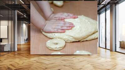 Traditional pastries. Homemade donuts. Photo 2: children's hands knead a baking dough with cottage cheese. Wall mural