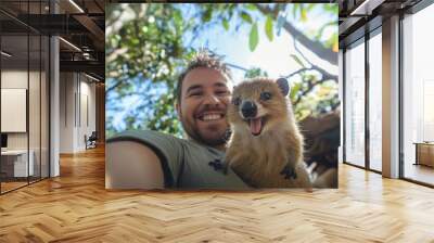 A cheerful young man smiles widely for a selfie with a cute animal. The joy shines in their expressions amidst a vibrant green setting. Perfect for wildlife and adventure themes. Generative AI Wall mural