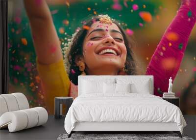 A joyful woman celebrating during a colorful festival. She is covered in vibrant powders that reflect happiness and excitement. A perfect moment of cultural richness. Generative AI Wall mural