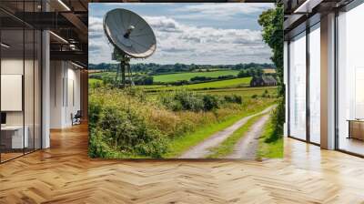 A large satellite dish stands proudly in a green rural landscape. This image captures the beauty of technology in nature. It conveys connection and communication. Generative AI Wall mural