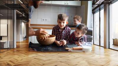 Young family making cookies at home Wall mural