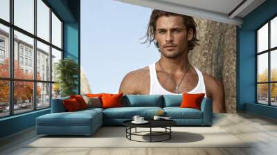 portrait of a handsome young tanned man in white open shirt on the background of the sea , photo Wall mural