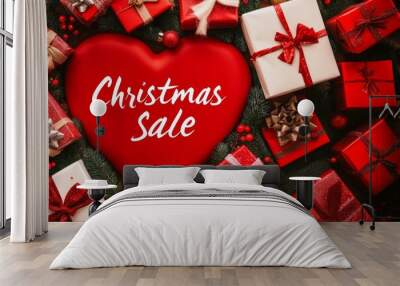 Red heart with inscription Christmas sales among gifts in red packages with ribbons, top view, photo. For decoration and design articles about lifestyle, holidays, christmas, traditions, valentines da Wall mural