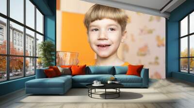 smiling young boy holds glass of water Wall mural