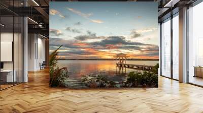 A view of a pier with a bungalow at sunset in the Caribbean. Wall mural