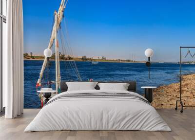 Felucca boat moored near the shore of Nile river in Luxor, Egypt Wall mural