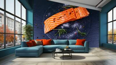 Raw salmon fillet with spices on black slate. Top view Wall mural