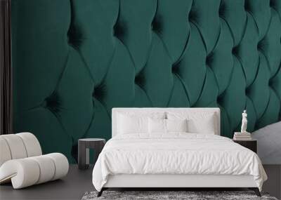 Closeup shot of a bed with green fabric headboard and white mattress Wall mural