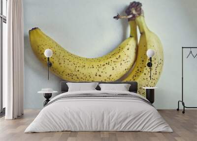 A bunch of two yellow bananas in brown specks Wall mural