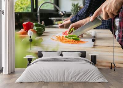 Close-up man cooking and slicing fresh vegetables on a rustic kitchen worktop, healthy eating concept, flat lay Wall mural