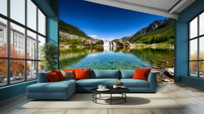 Ambrosial scene from the Sibillini Mountains with Cascata del Pellegrino in a long-exposure shot, the creamy waters of the scant waterfall merging with a mirror-like almost transparent body of water Wall mural