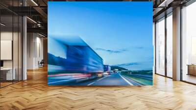 Background photograph of a highway. Truck on a motorway, motion blur, light trails. Evening or night shot of trucks doing logistics and transportation on a highway. Wall mural