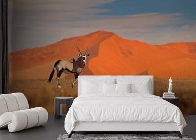 Gemsbok with orange sand dune evening sunset. Gemsbuck, Oryx gazella, large antelope in nature habitat, Sossusvlei, Namibia. Wild animals in the savannah. Animal with big straight antler horn. Wall mural