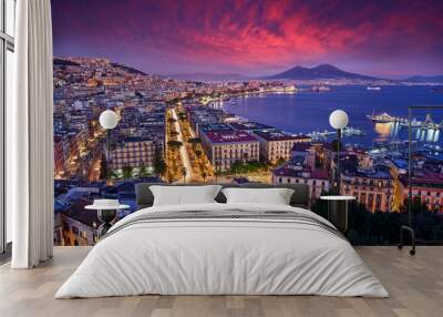 Naples, twilight evening pink violet sunset. Town Napoli in Italy, travelling in the Europe. Urban landscape with city, sea, hills and Vesuvio Volcano. Beautiful sunset sky, end of the day. Wall mural