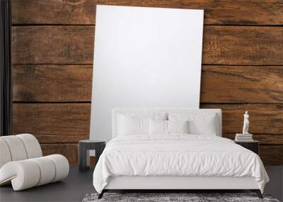 Empty white paper sheet on rustic wooden table. Top view Wall mural