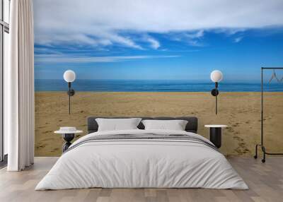 White clouds, blue sea and yellow sandy beach Wall mural