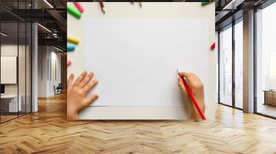 Kid hands drawing at the table with pencils, white paper, school activities background Wall mural