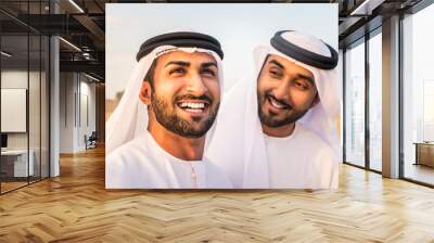 Arabic men in the desert of Dubai wearing traditional emirates clothing Wall mural