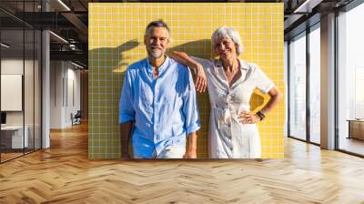 Beautiful happy senior couple dating at the seaside during summertime Wall mural