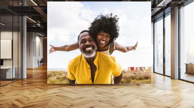 Beautiful mature senior black couple of lovers dating at the seaside - Married african middle-aged couple bonding and having fun outdoors, concepts about relationship, lifestyle and quality of life Wall mural