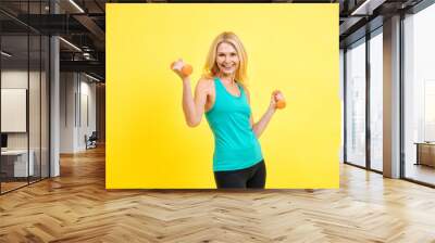 Beautiful middle aged woman making sport at the gym Wall mural