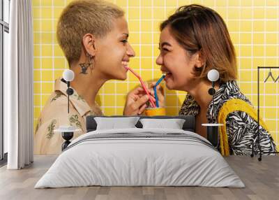 Beautiful multiethnic lesbian couple of lovers dating outdoors - LGBT people bonding and spending time together, concepts about LGBTQ community, diversity, love and lifestyle Wall mural