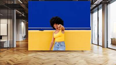 Beautiful young black woman outdoors in the city - Afro american cheerful female adult portrait Wall mural