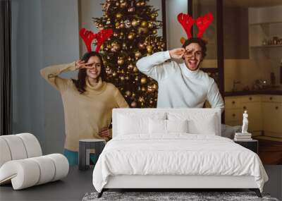 Cinematic image of a couple celebrating christmas at home. Wall mural