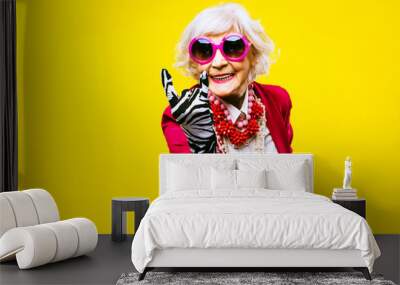 Cool and stylish senior old woman with fashionable clothes - Funny colorful portrait of elderly female lady on colored background Wall mural