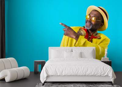 Cool senior african man with fashionable outfit portrait - Old and funny black grandfather portrait on colorful background Wall mural