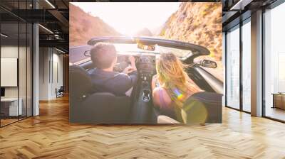 Couple driving fast on a sport convertible car in the canyons.  Wall mural